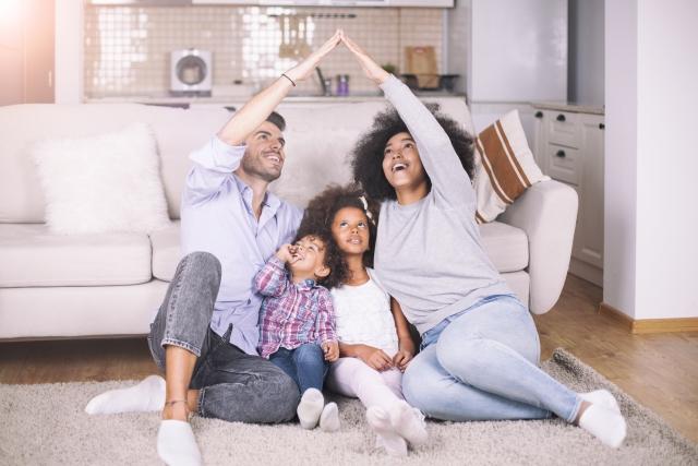 Family sitting in front of a couch